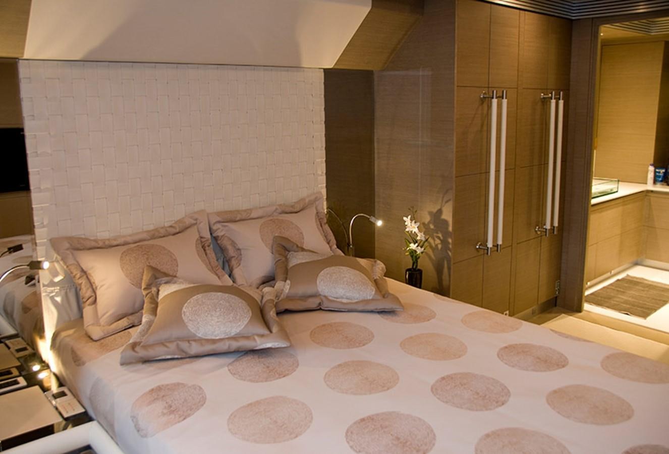 a bed with white sheets and pillows aboard RL NOOR Yacht for Sale