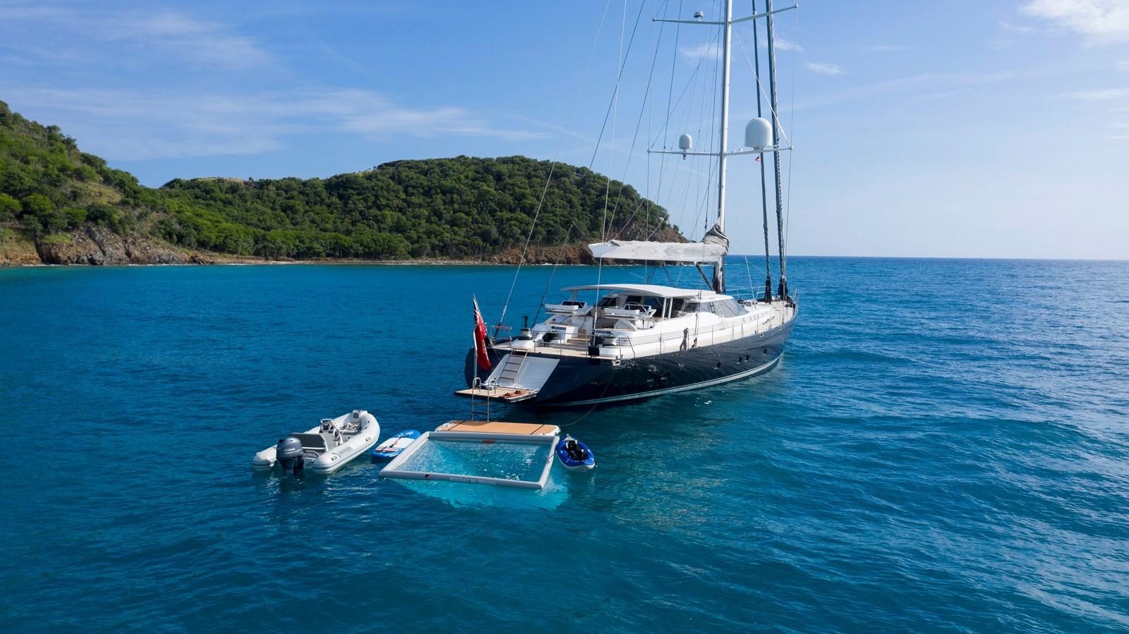 a boat and a small boat in the water aboard RADIANCE Yacht for Sale