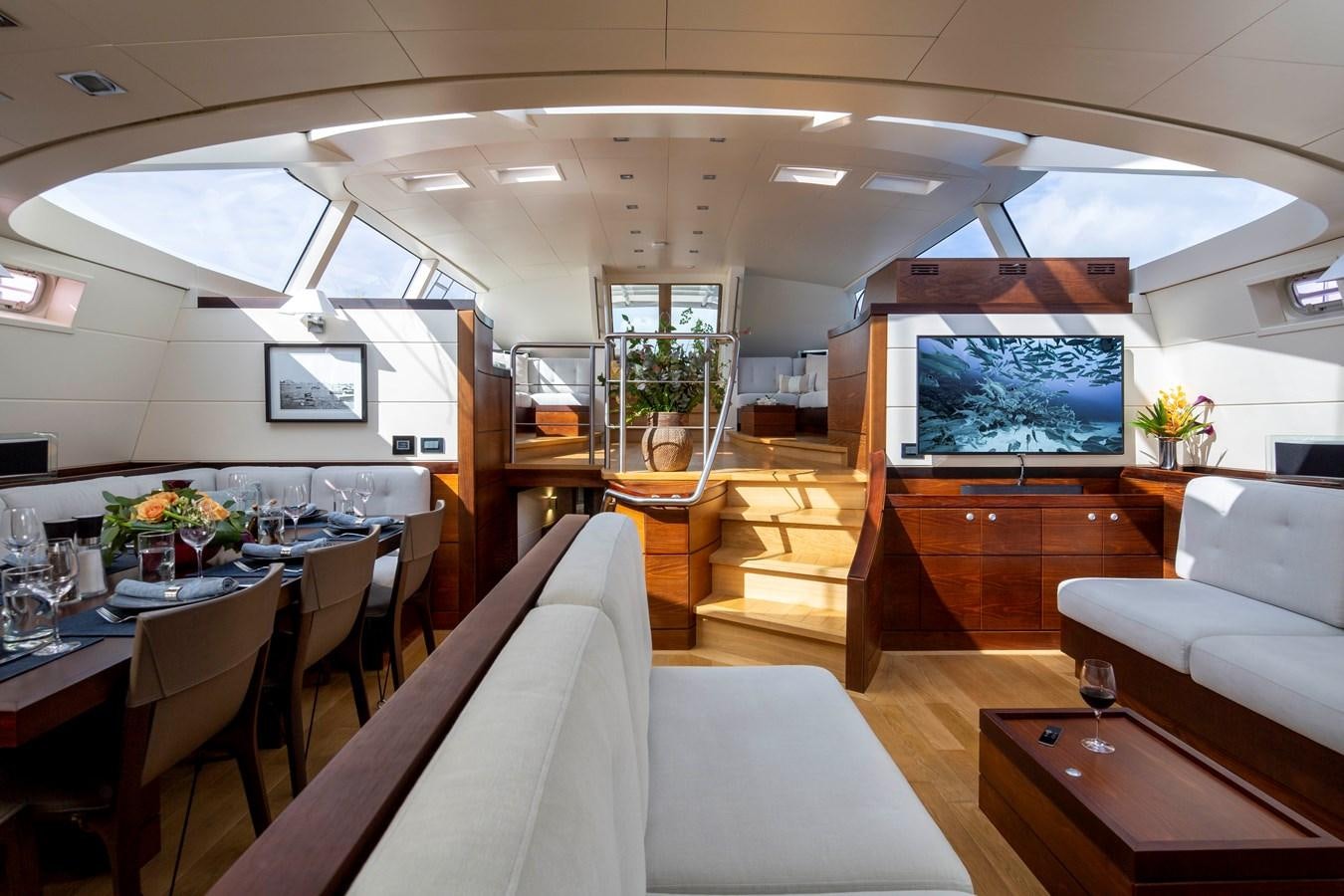 a room with tables and chairs aboard RADIANCE Yacht for Sale