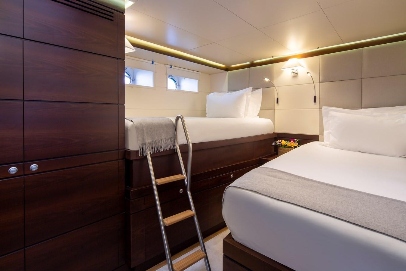 a room with a bunk bed and a ladder aboard RADIANCE Yacht for Sale