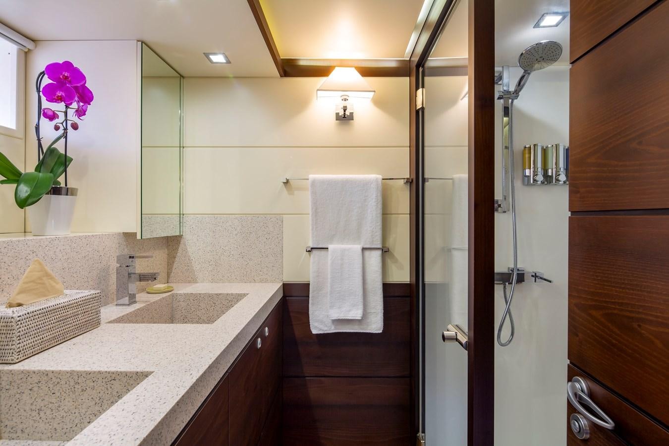 a bathroom with a sink and a shower aboard RADIANCE Yacht for Sale