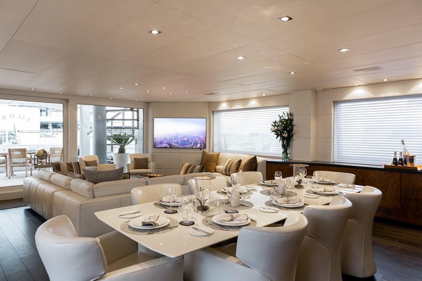 a large room with a table and chairs aboard PALM B Yacht for Sale