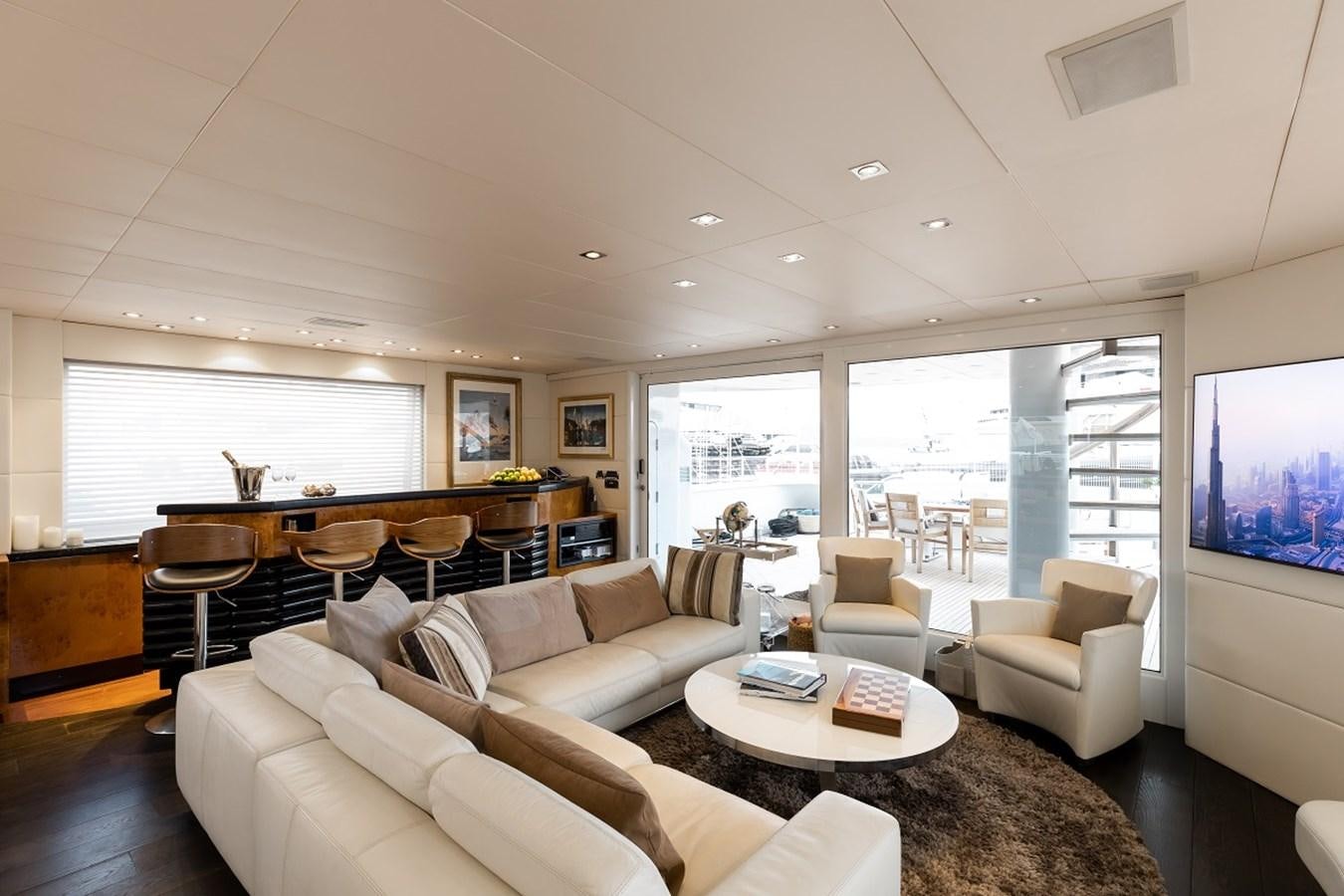 a living room with a large window aboard PALM B Yacht for Sale