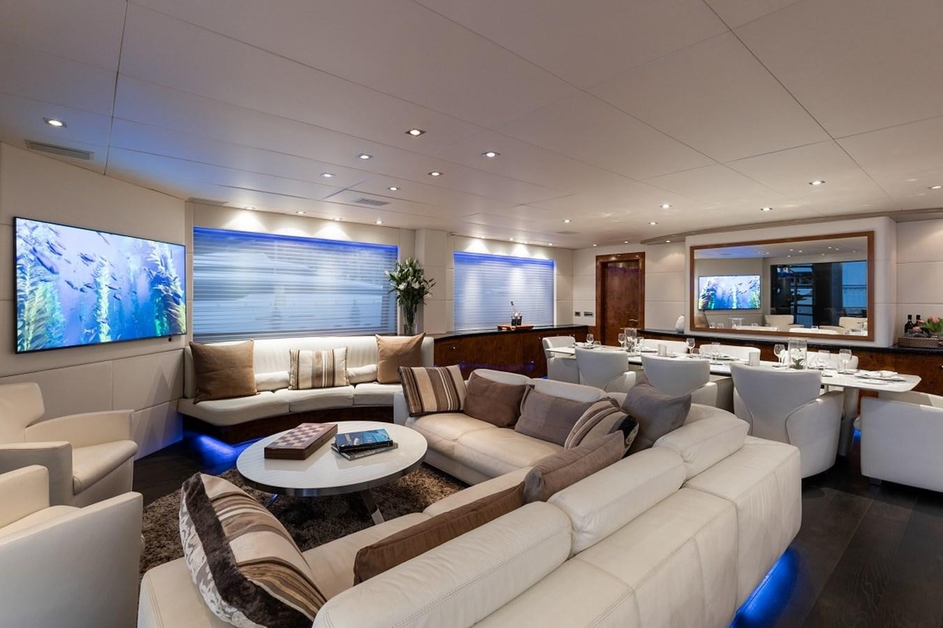 a living room with a large sofa aboard PALM B Yacht for Sale