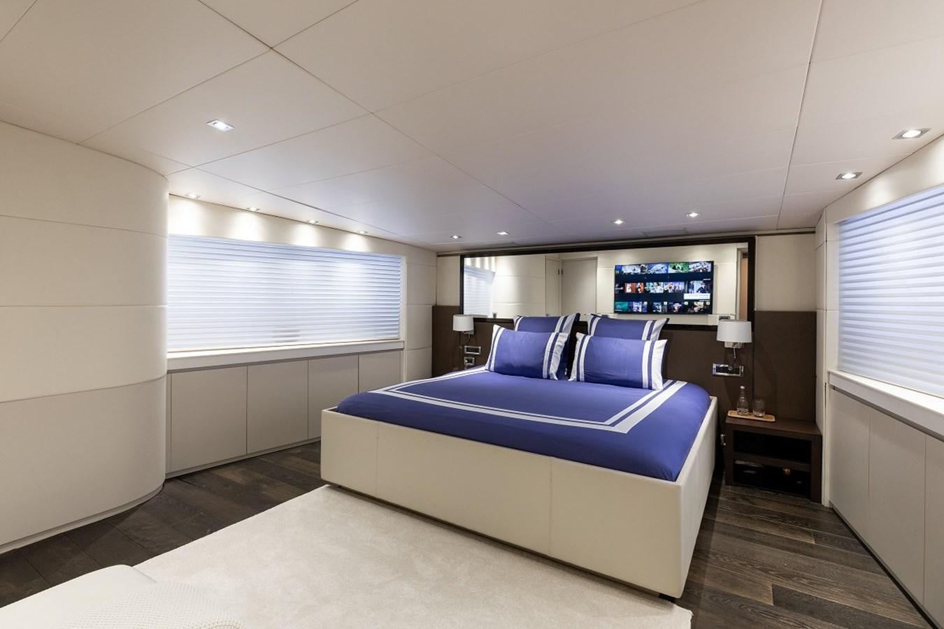a room with a bed and a tv on the wall aboard PALM B Yacht for Sale