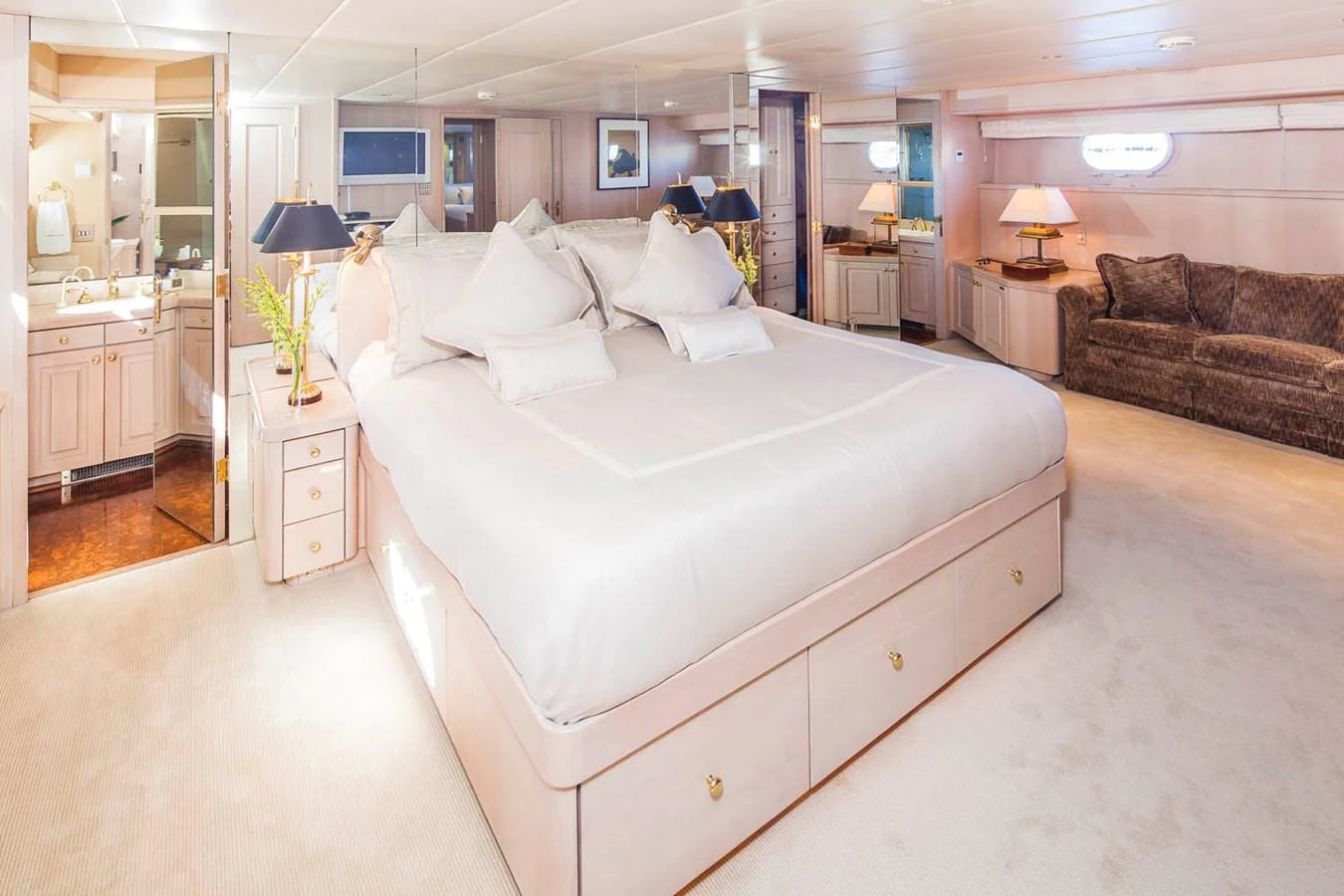 a large bedroom with a bed and a couch aboard SILENT WORLD II Yacht for Sale