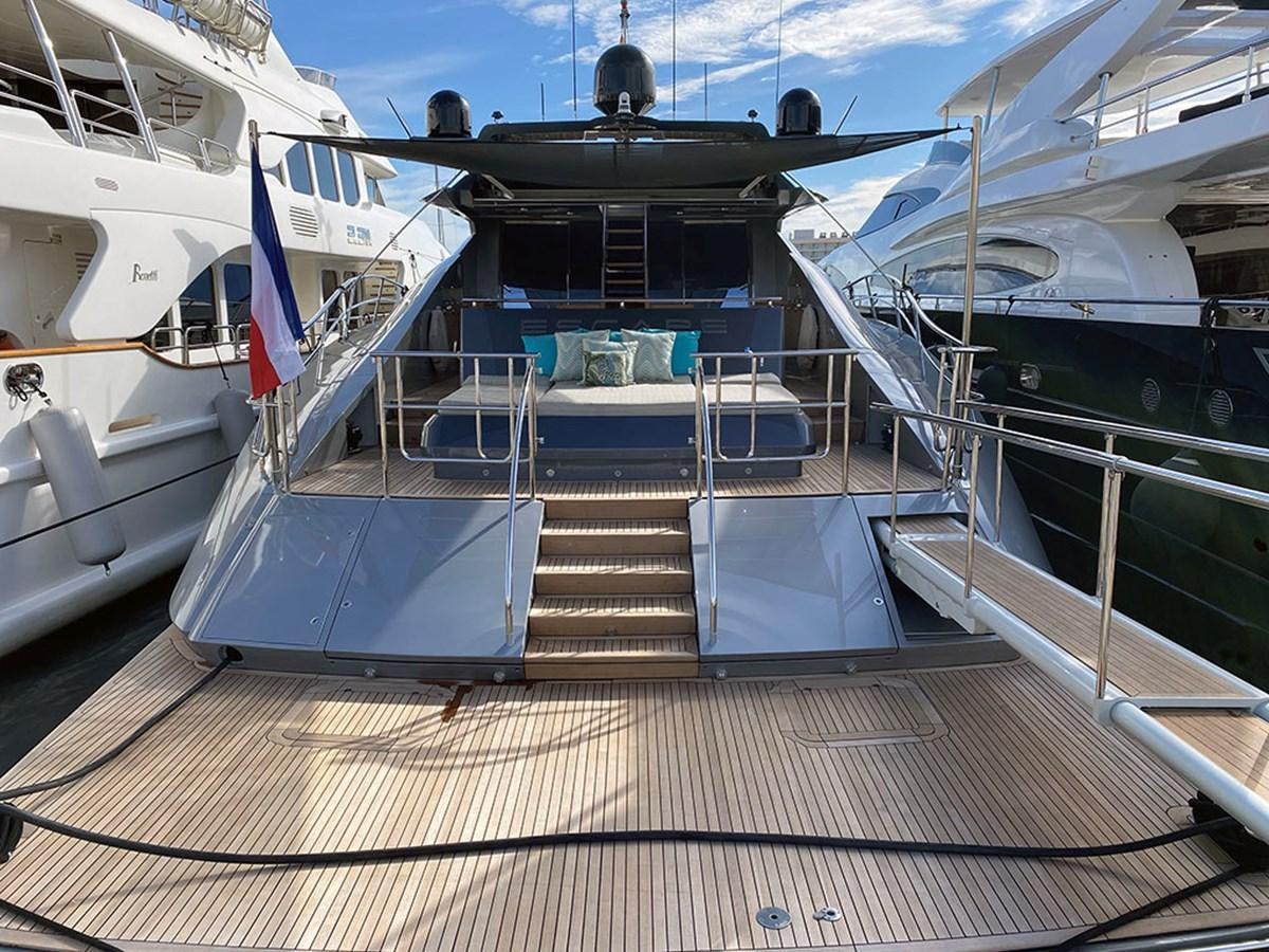 a boat with a flag on the deck aboard ESCAPE Yacht for Sale