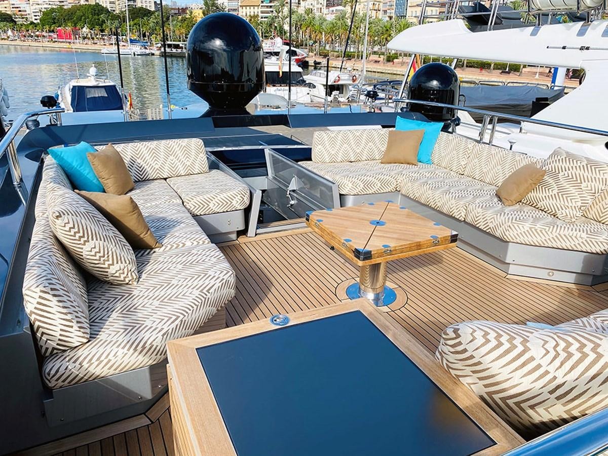a deck with a couch and a table on it aboard ESCAPE Yacht for Sale