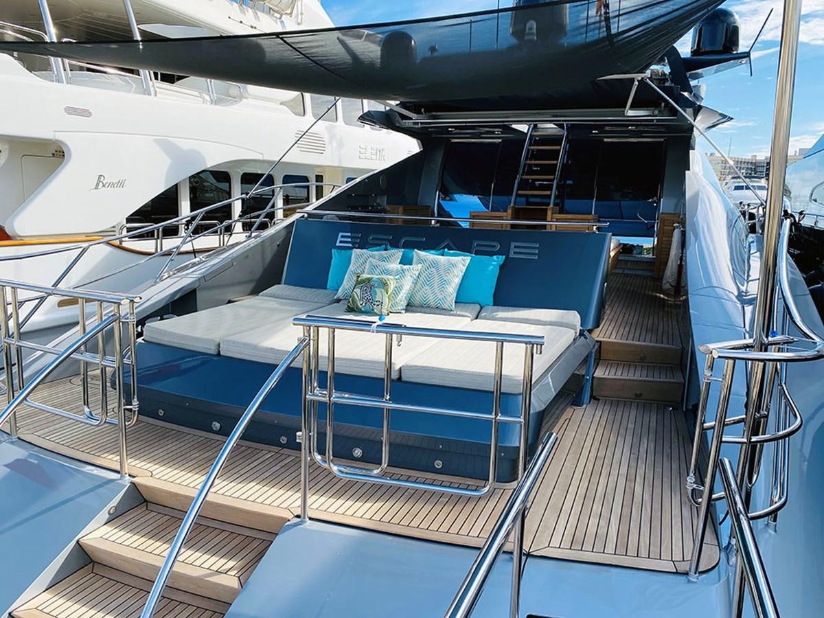 a large white boat with blue seats aboard ESCAPE Yacht for Sale