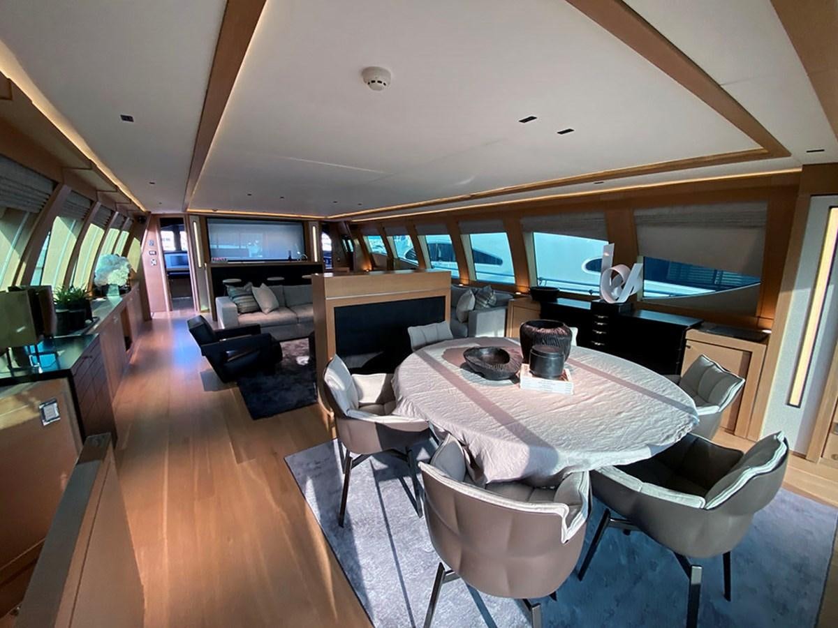 a large room with a table and chairs aboard ESCAPE Yacht for Sale