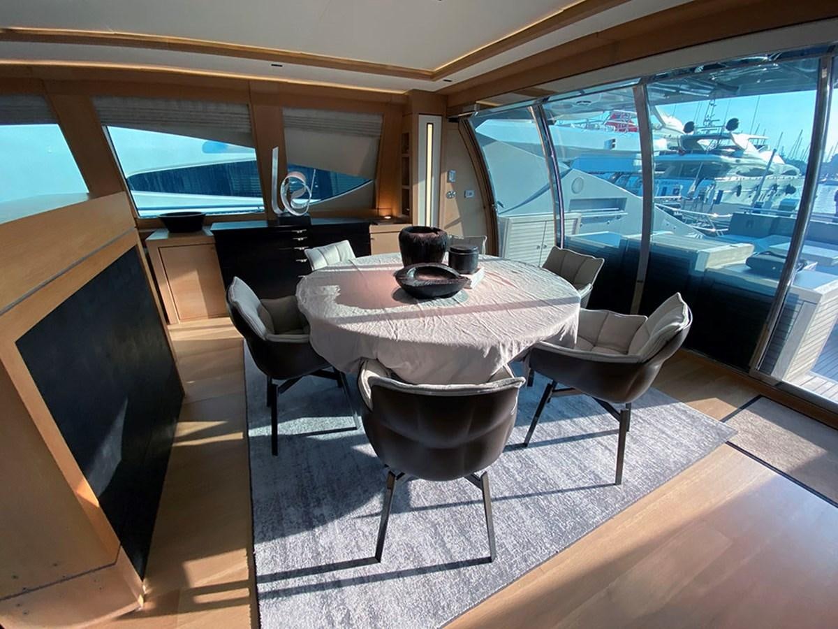 a table and chairs in a room aboard ESCAPE Yacht for Sale