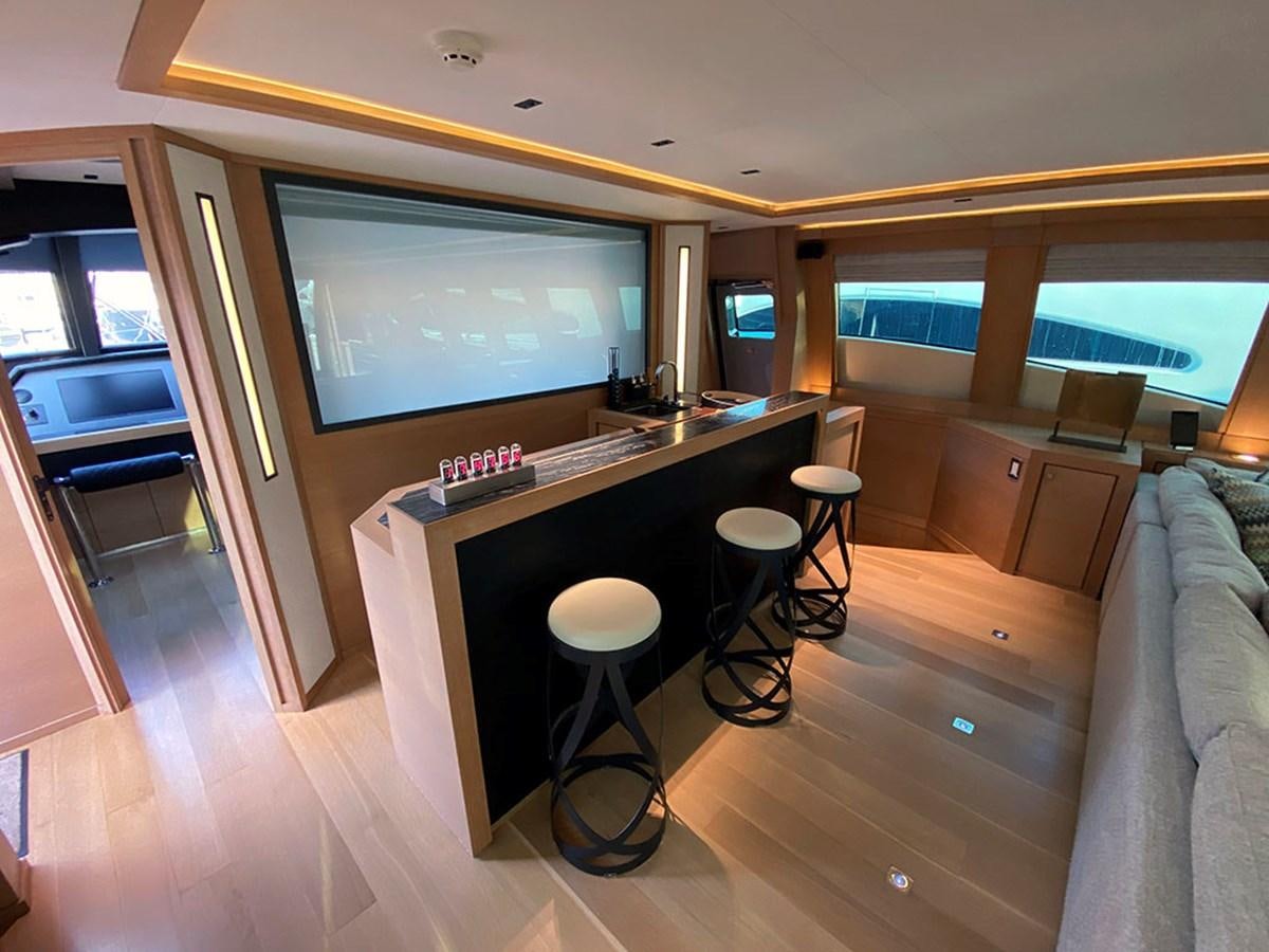 a room with a tv and a table aboard ESCAPE Yacht for Sale