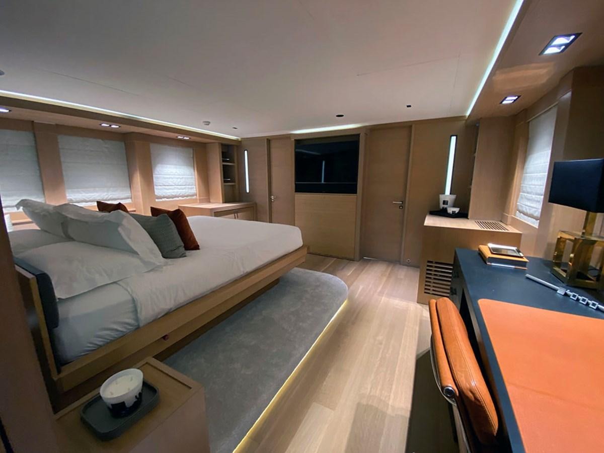 a bedroom with a bed and desk aboard ESCAPE Yacht for Sale