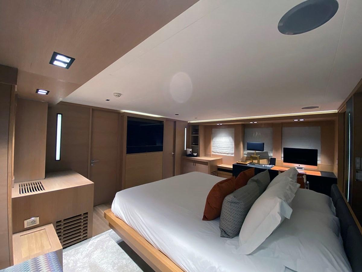 a bedroom with a bed and a desk aboard ESCAPE Yacht for Sale