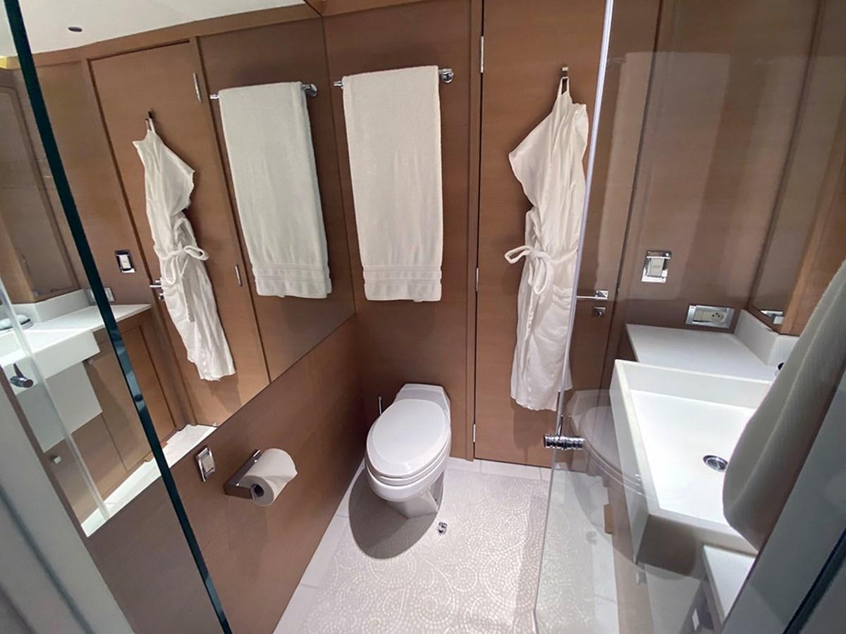 a bathroom with a toilet and a sink aboard ESCAPE Yacht for Sale