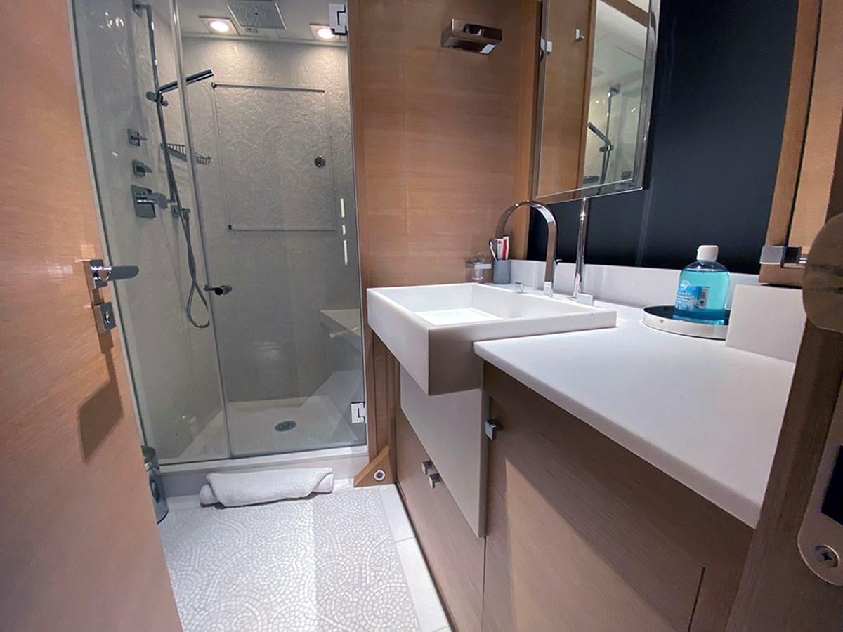 a bathroom with a shower sink and a mirror aboard ESCAPE Yacht for Sale