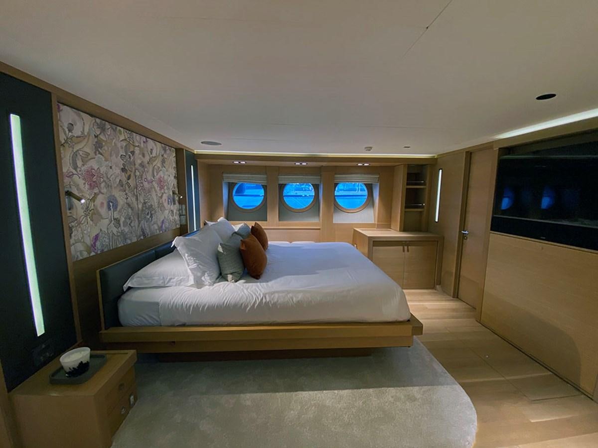 a bedroom with a bed and a tv aboard ESCAPE Yacht for Sale