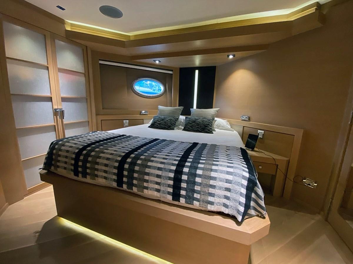 a bed with a blue and white comforter aboard ESCAPE Yacht for Sale