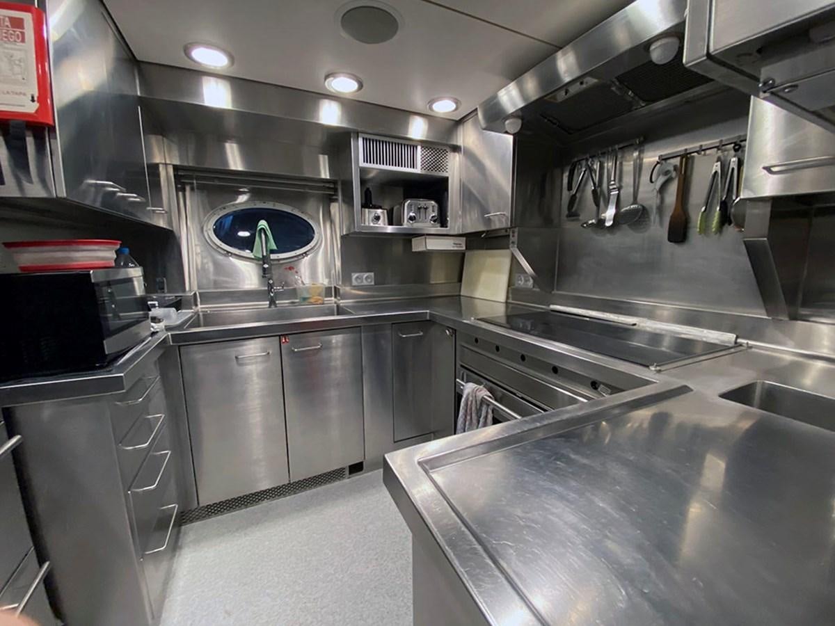 a kitchen with stainless steel appliances aboard ESCAPE Yacht for Sale