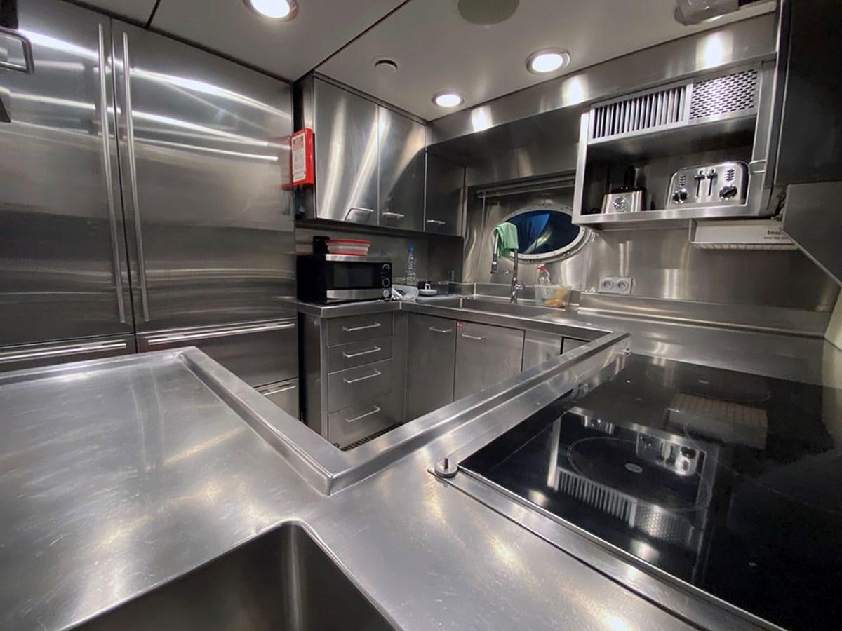 a kitchen with stainless steel appliances aboard ESCAPE Yacht for Sale