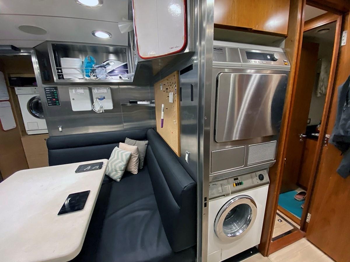a small kitchen with a washing machine aboard ESCAPE Yacht for Sale