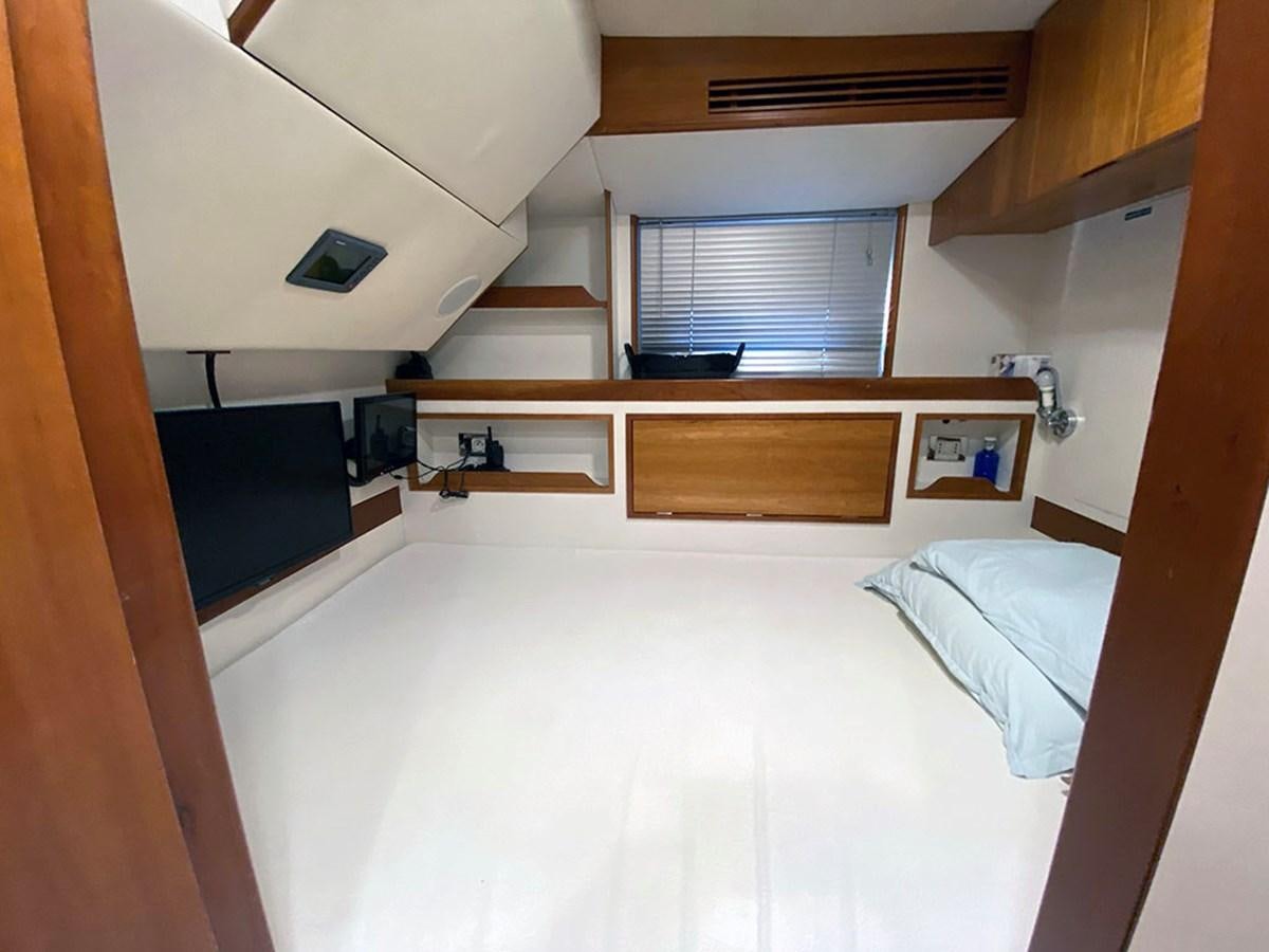 a room with a bed and a window aboard ESCAPE Yacht for Sale