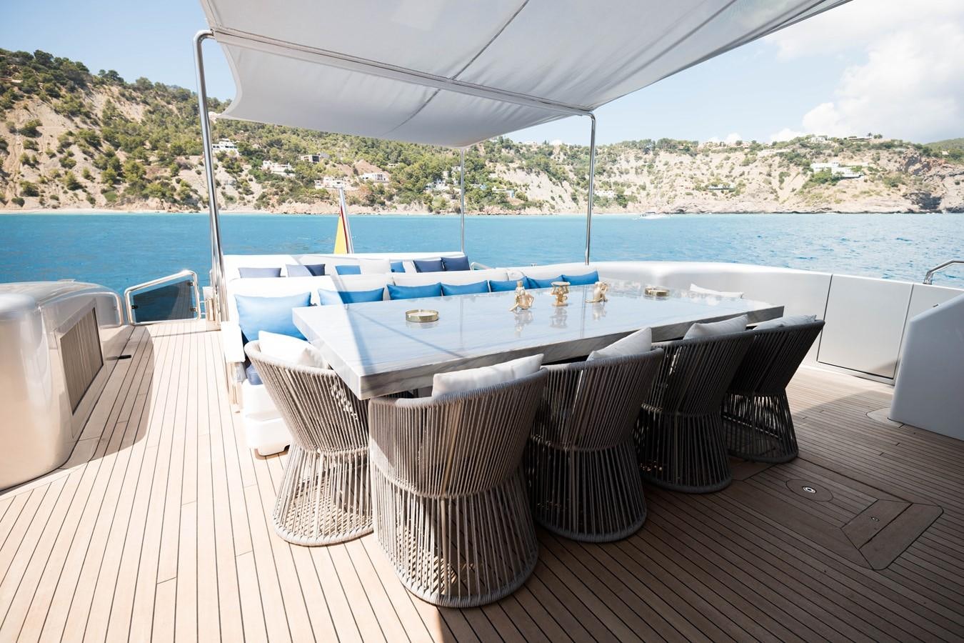 a table set up on a deck overlooking a large body of water aboard EVA Yacht for Sale