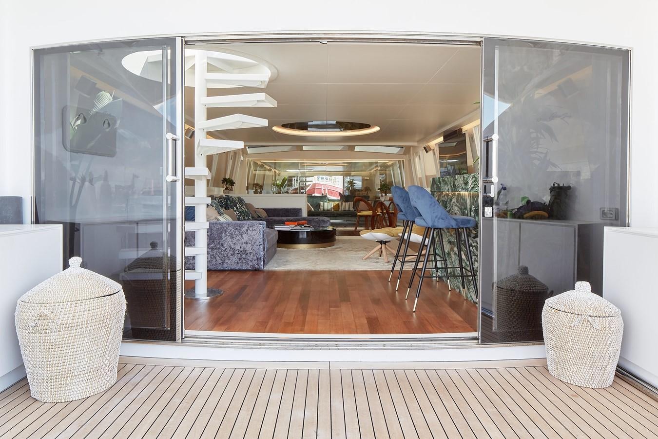 a room with a wood floor and a glass door aboard EVA Yacht for Sale