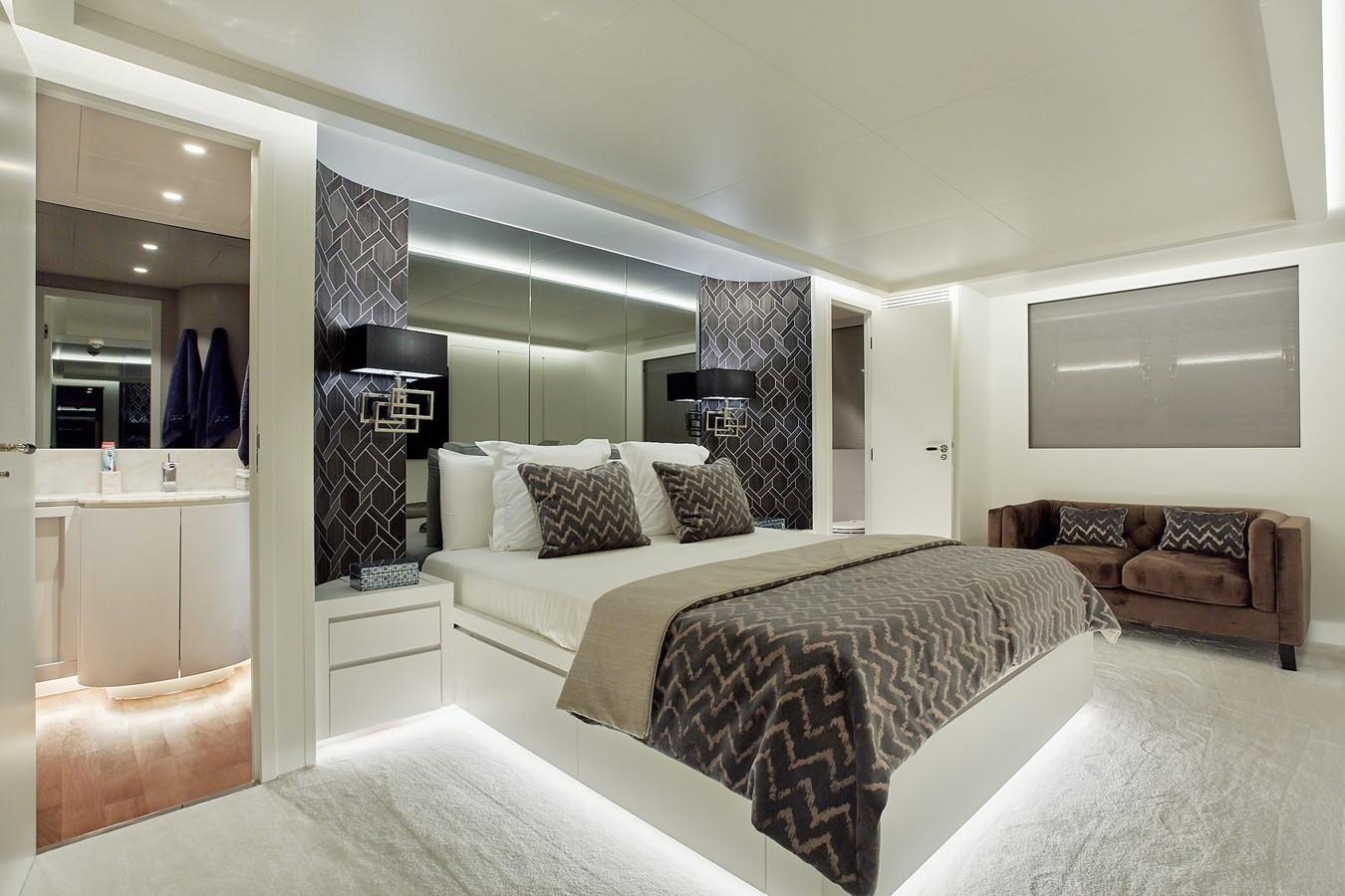 a bedroom with a bed and a couch aboard EVA Yacht for Sale