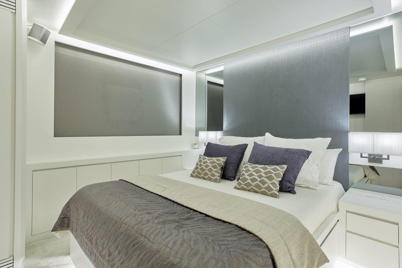 a bedroom with a bed and a large mirror aboard EVA Yacht for Sale