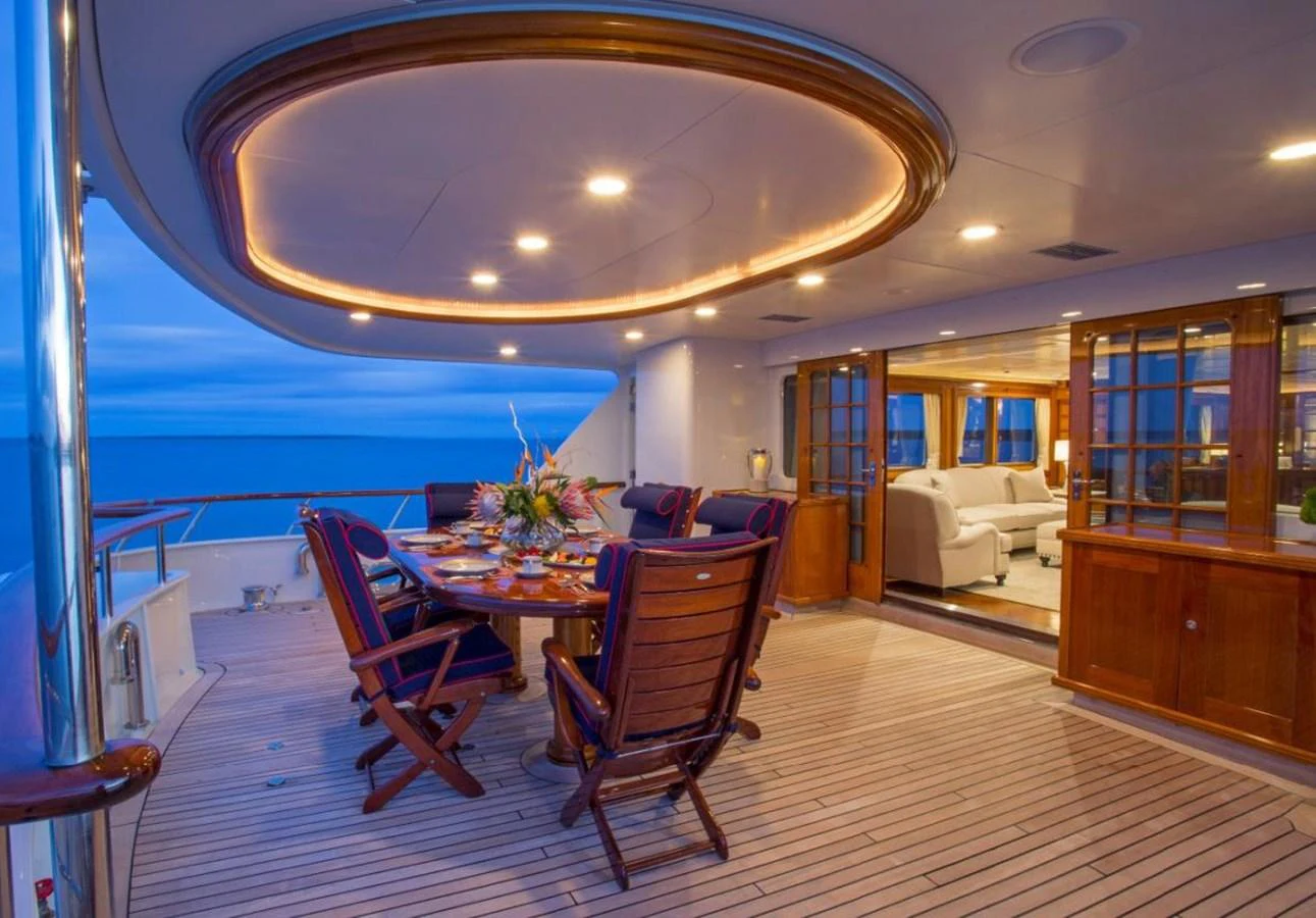 a large room with a table and chairs aboard LADY VICTORIA Yacht for Sale