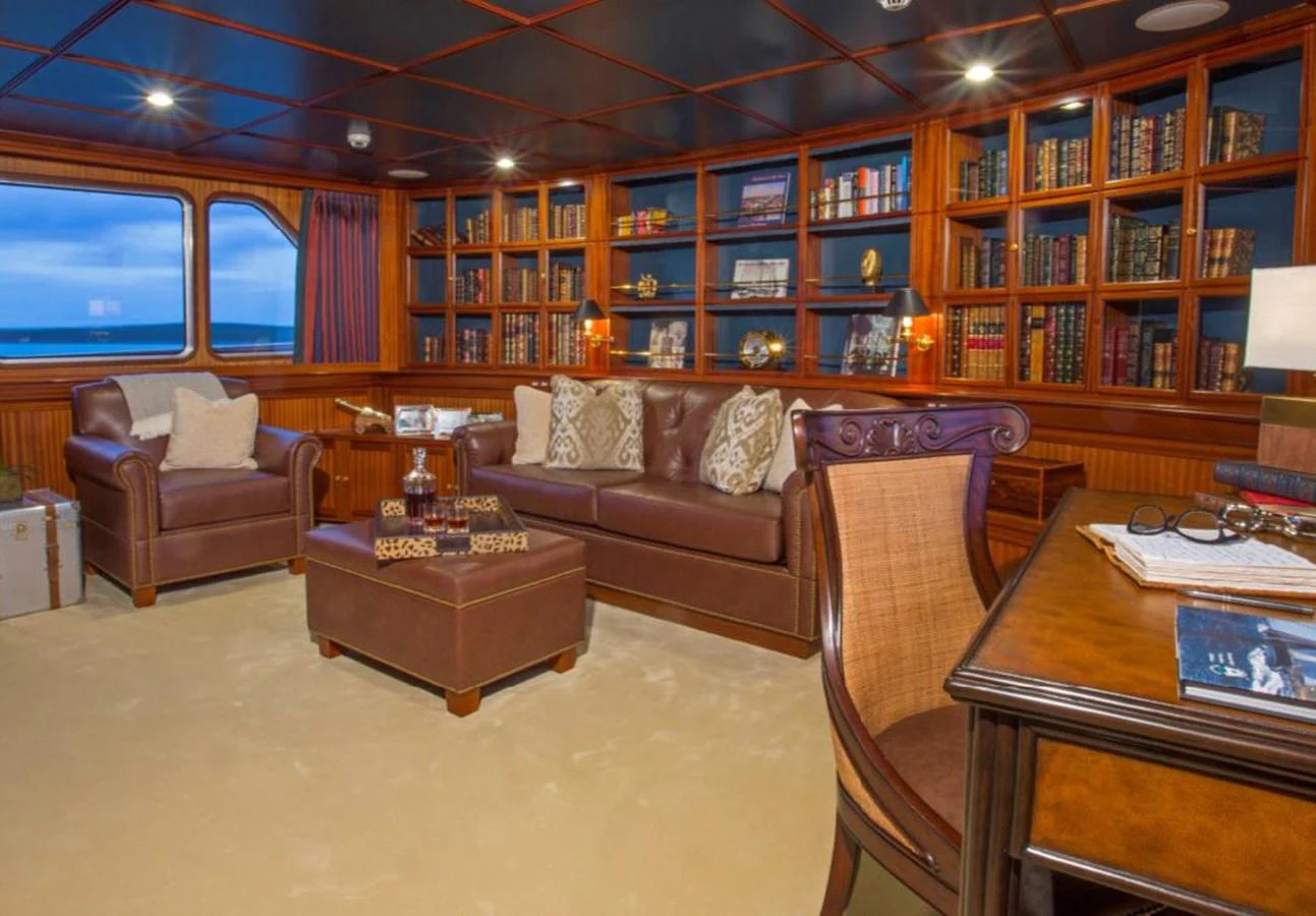 a living room with leather couches aboard LADY VICTORIA Yacht for Sale