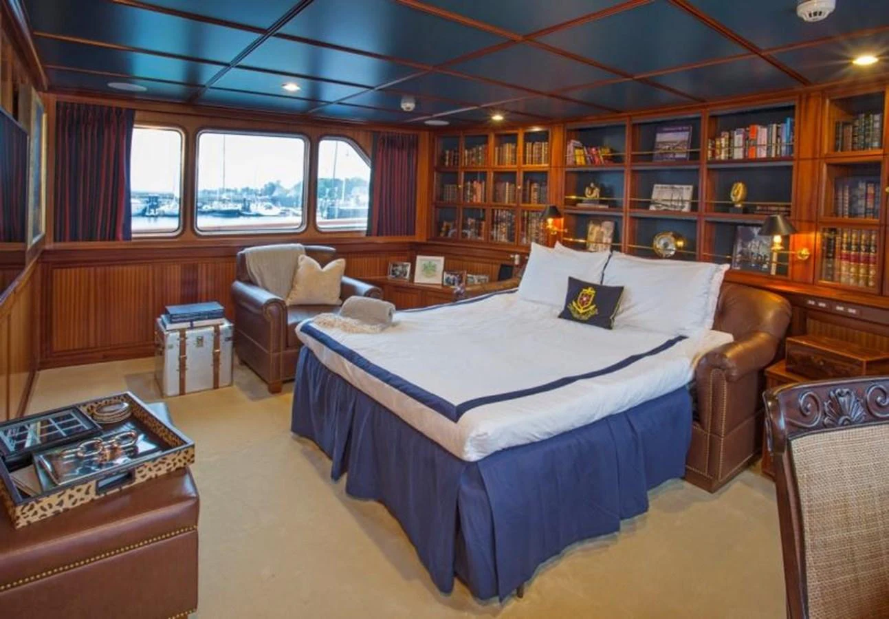 a bedroom with a large bed aboard LADY VICTORIA Yacht for Sale