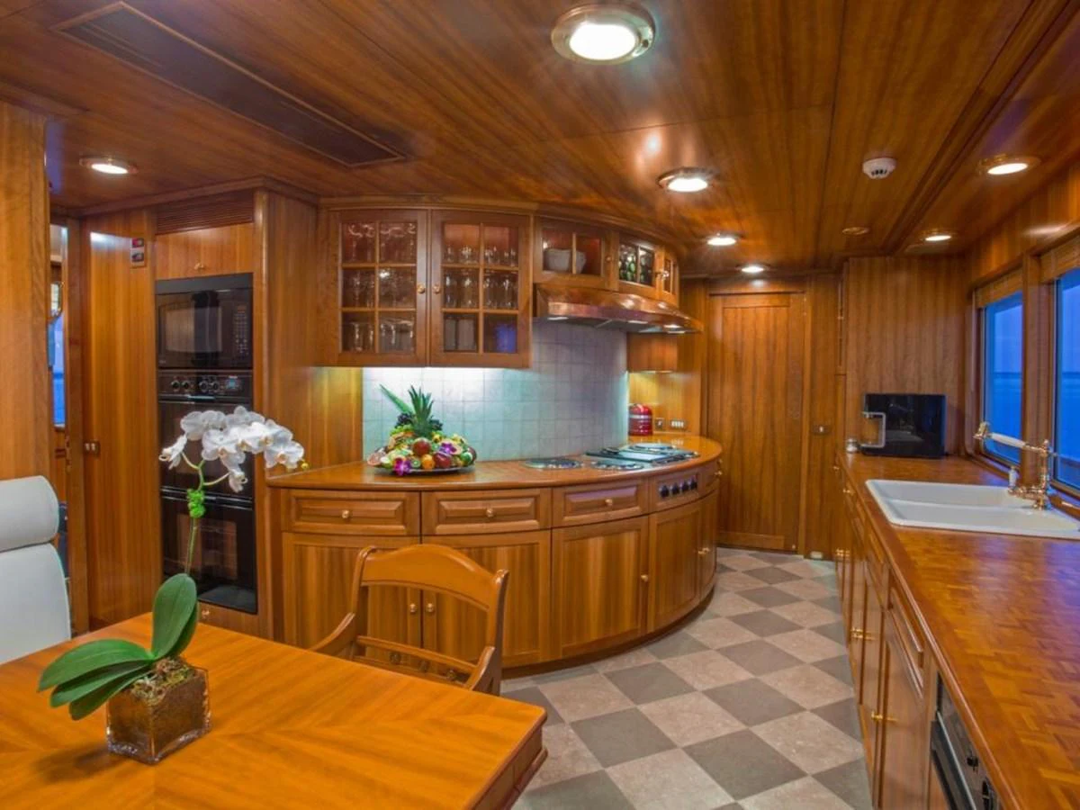 a kitchen with wooden cabinets aboard LADY VICTORIA Yacht for Sale