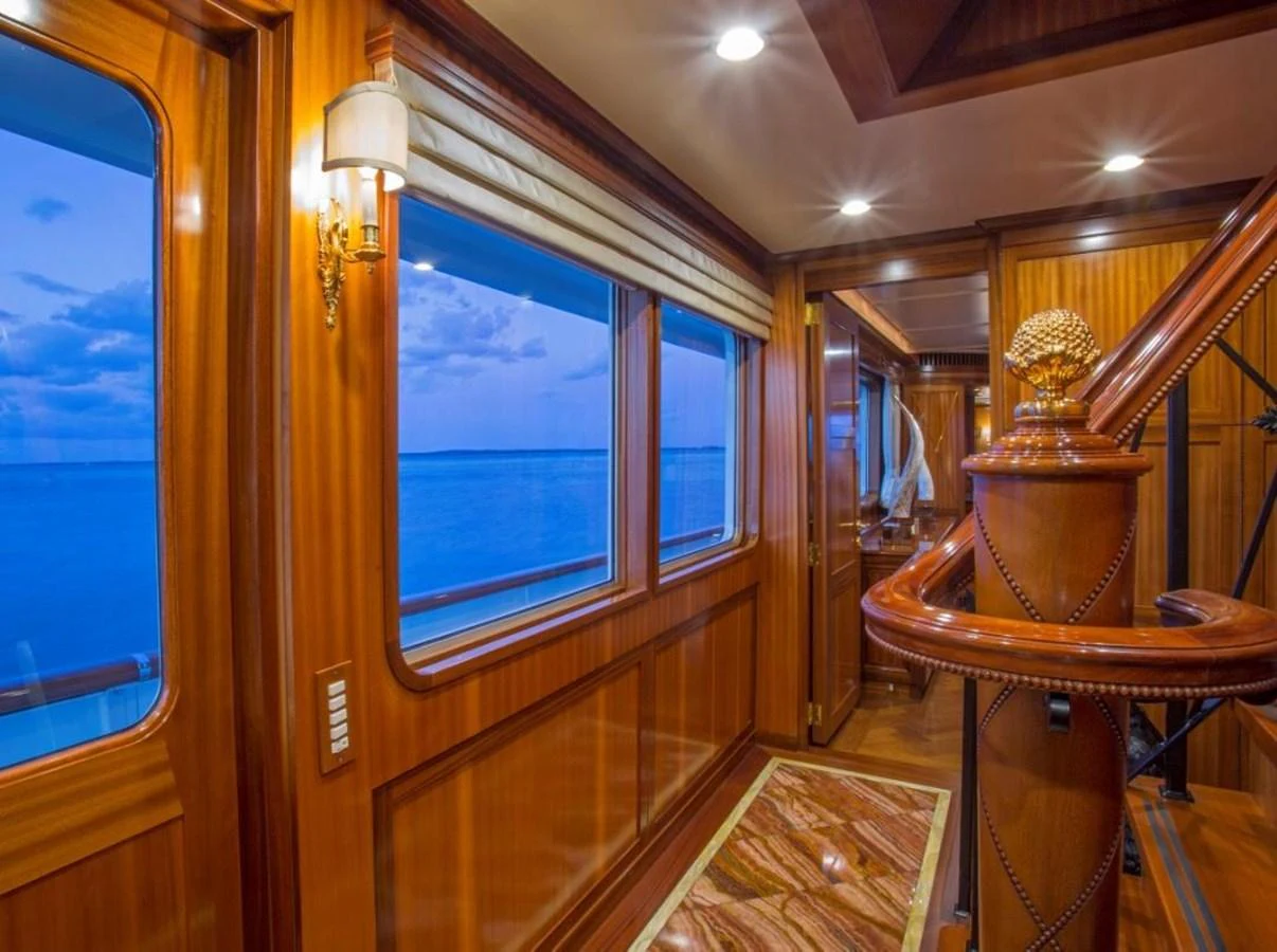 a room with a wood floor and a window with a wood railing aboard LADY VICTORIA Yacht for Sale