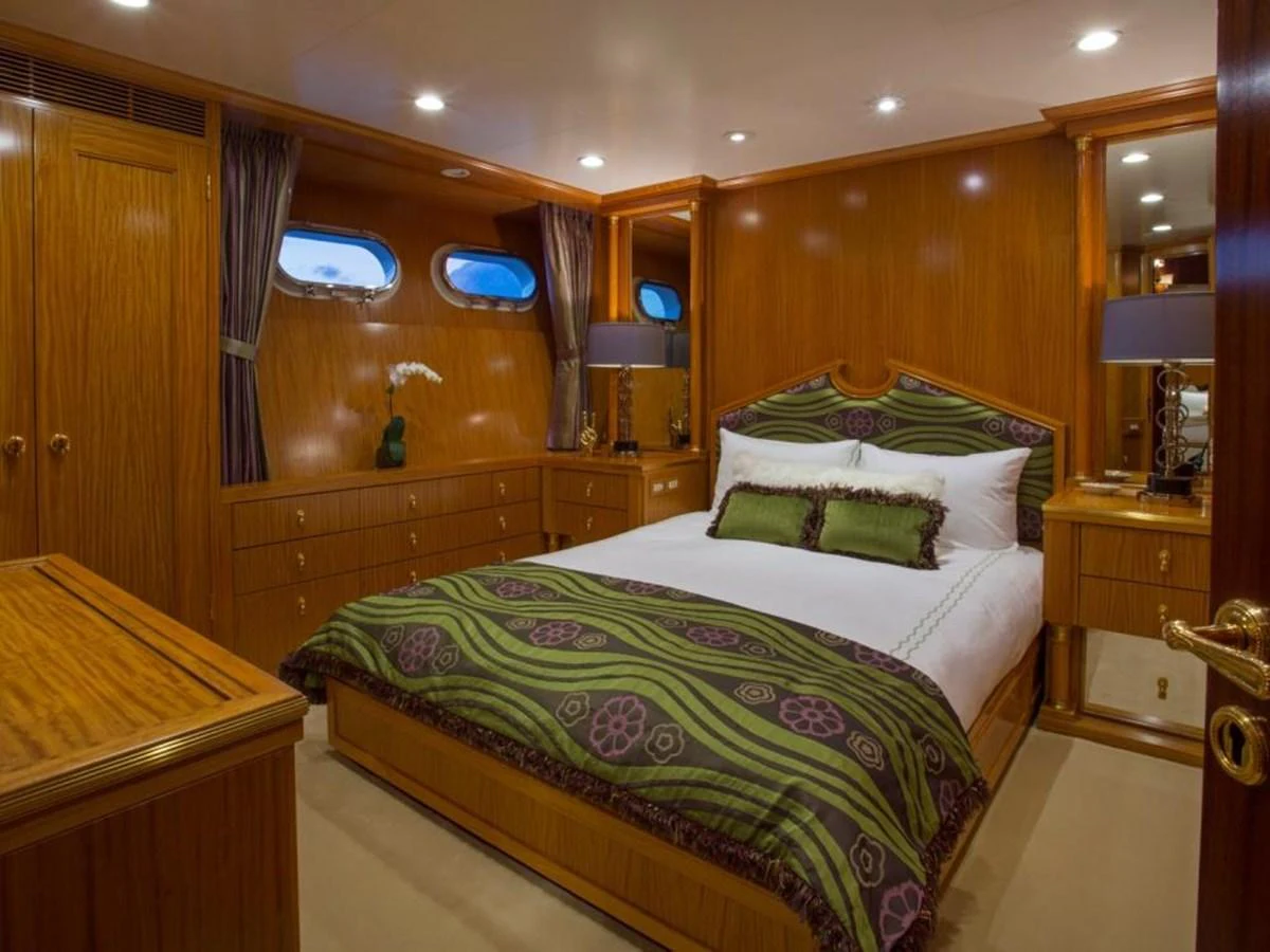 a bedroom with a bed and a desk aboard LADY VICTORIA Yacht for Sale