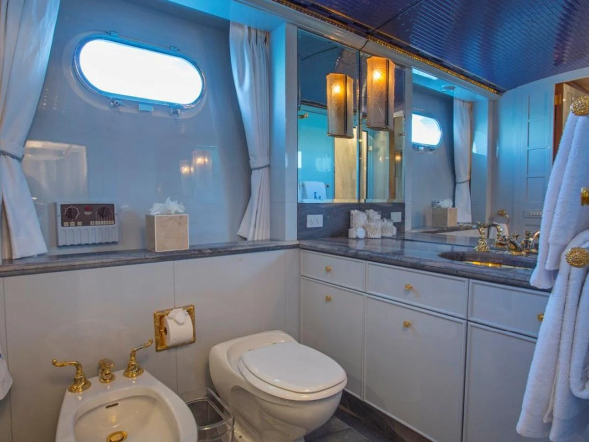 a bathroom with a sink toilet and a mirror aboard LADY VICTORIA Yacht for Sale