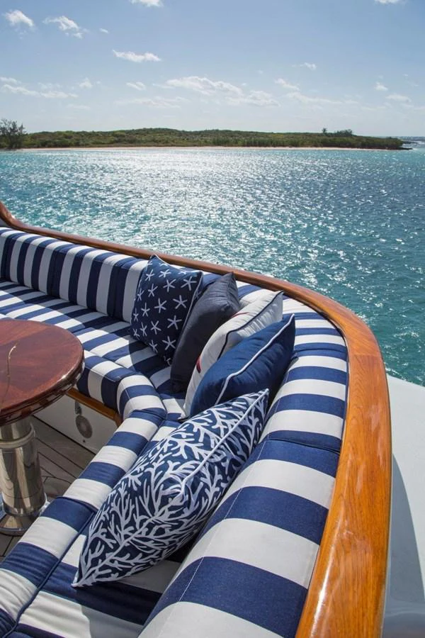a boat with a striped seat on the water aboard LADY VICTORIA Yacht for Sale