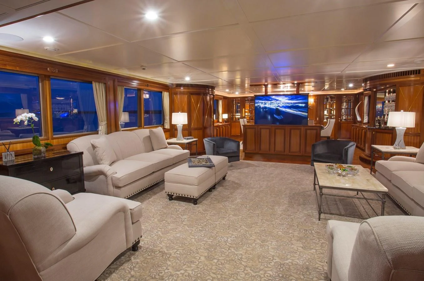 a living room with a large screen aboard LADY VICTORIA Yacht for Sale