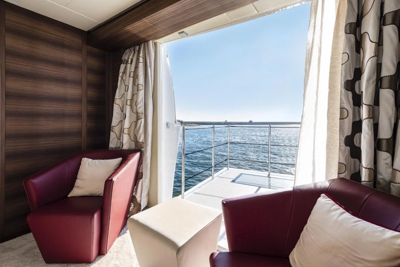 a room with a balcony aboard HARMONY Yacht for Sale