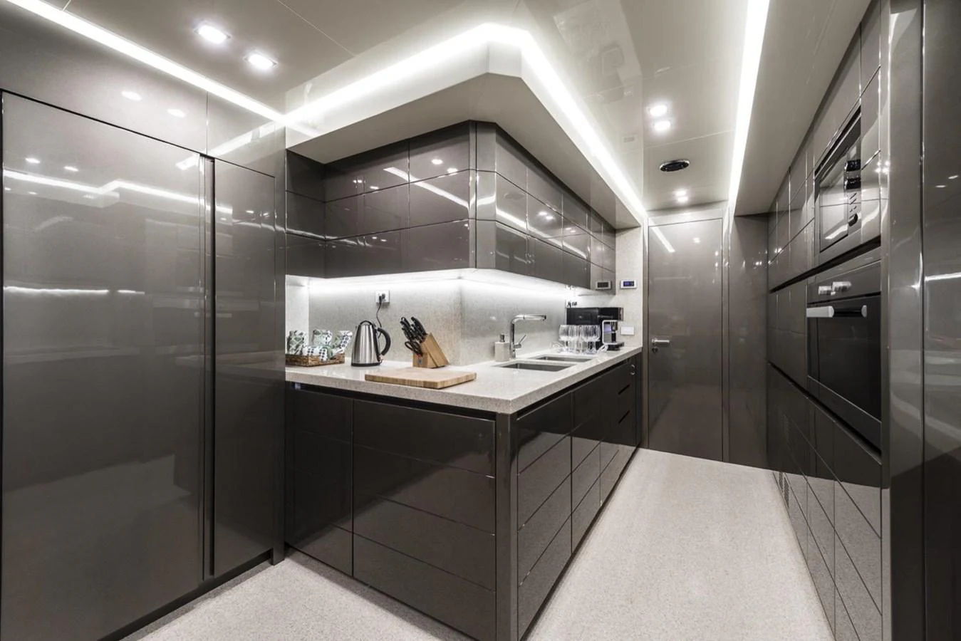 a kitchen with a sink and a refrigerator aboard HARMONY Yacht for Sale