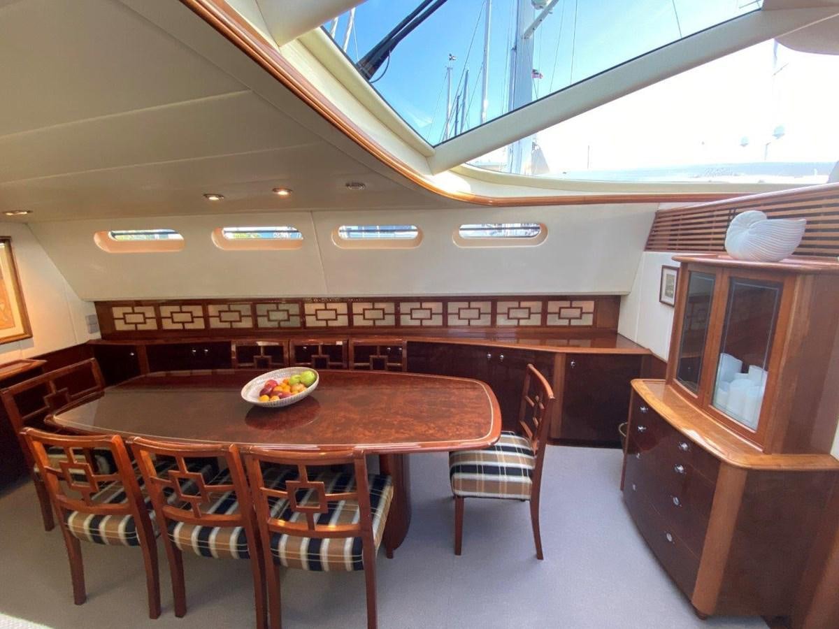 a room with a table and chairs aboard MISS SILVER Yacht for Sale