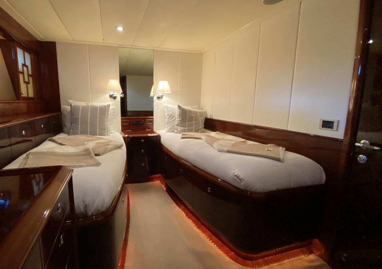 a hotel room with two beds aboard MISS SILVER Yacht for Sale