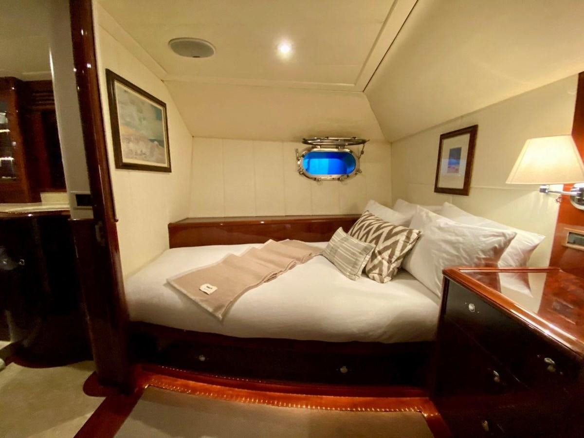 a bed with a red and white bed spread aboard MISS SILVER Yacht for Sale