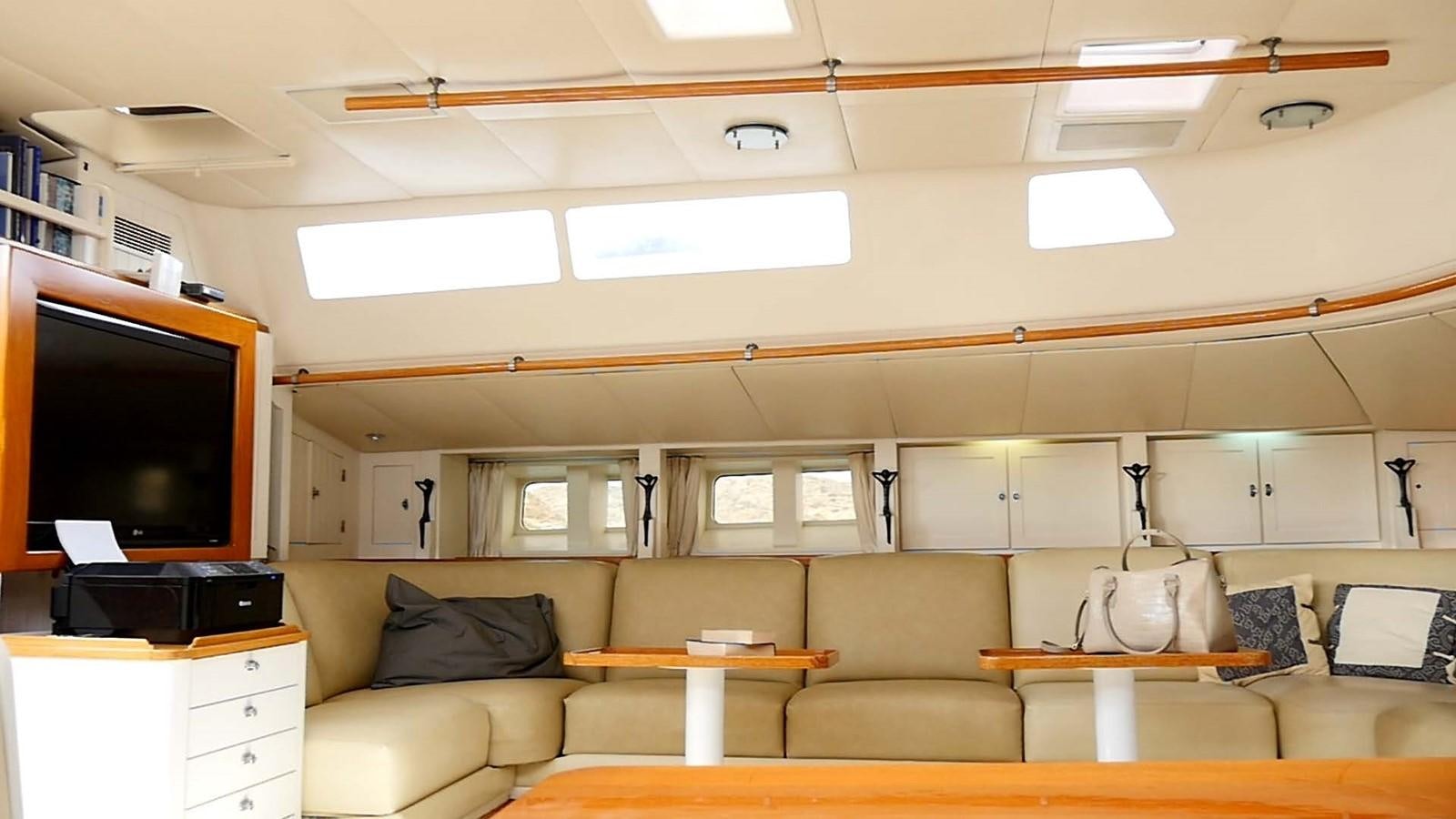 a living room with a couch and a tv aboard INGENIOUS Yacht for Sale