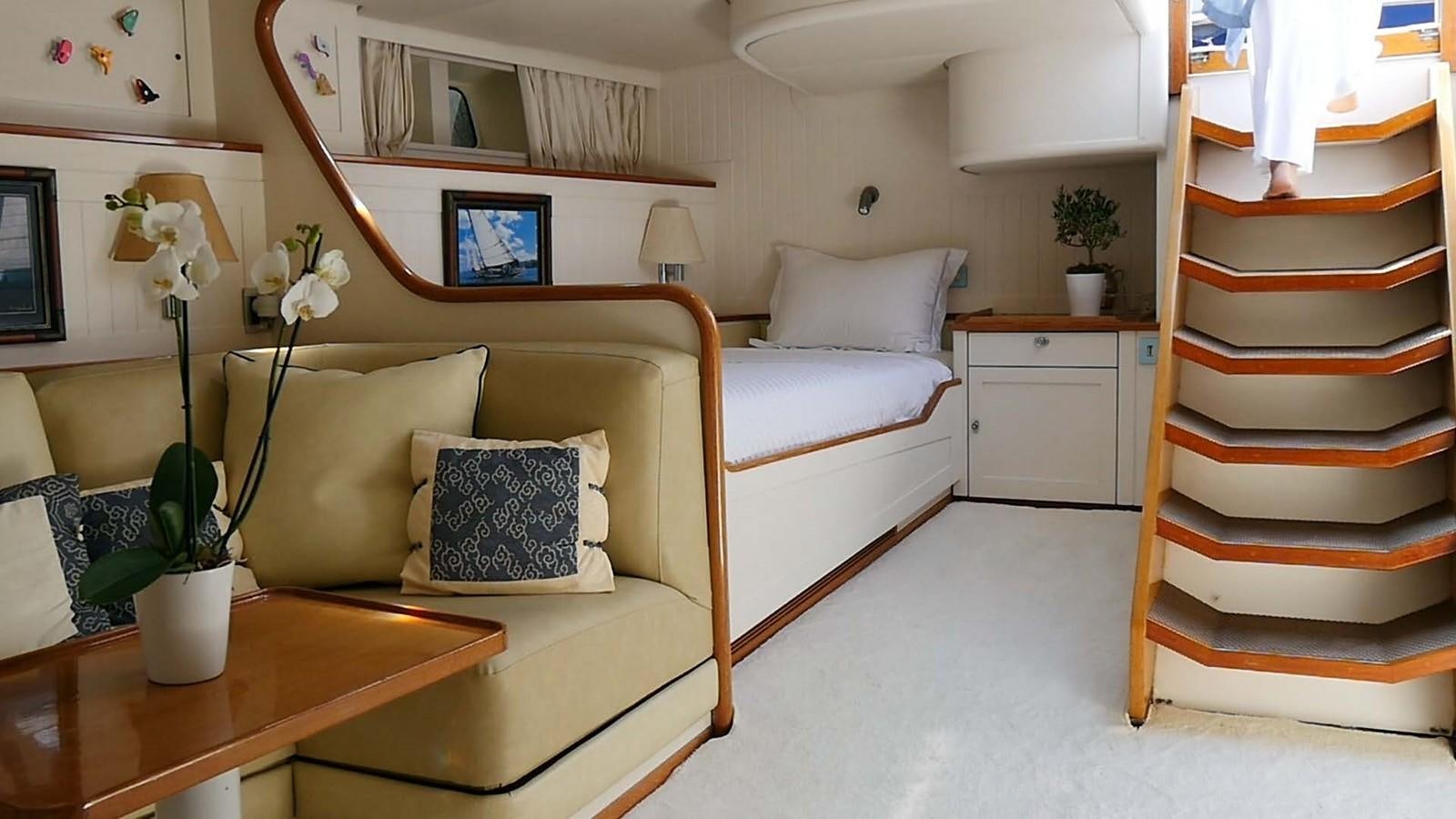 a room with a bed and a desk aboard INGENIOUS Yacht for Sale
