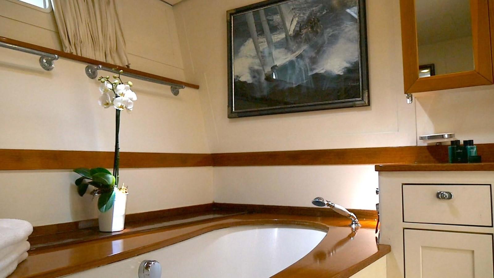 a bathroom with a painting on the wall aboard INGENIOUS Yacht for Sale