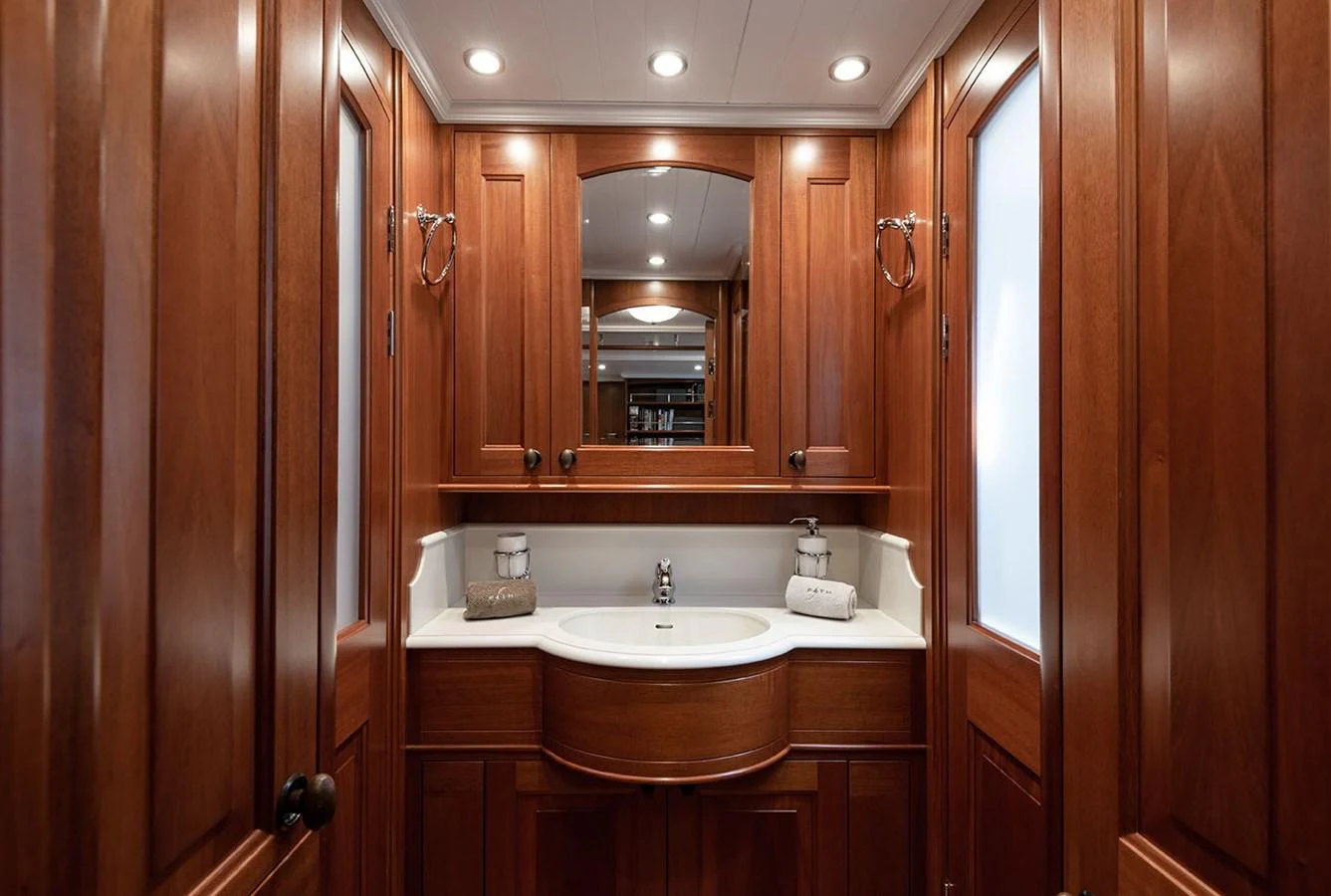 a bathroom with a sink and cabinets aboard PATH Yacht for Sale