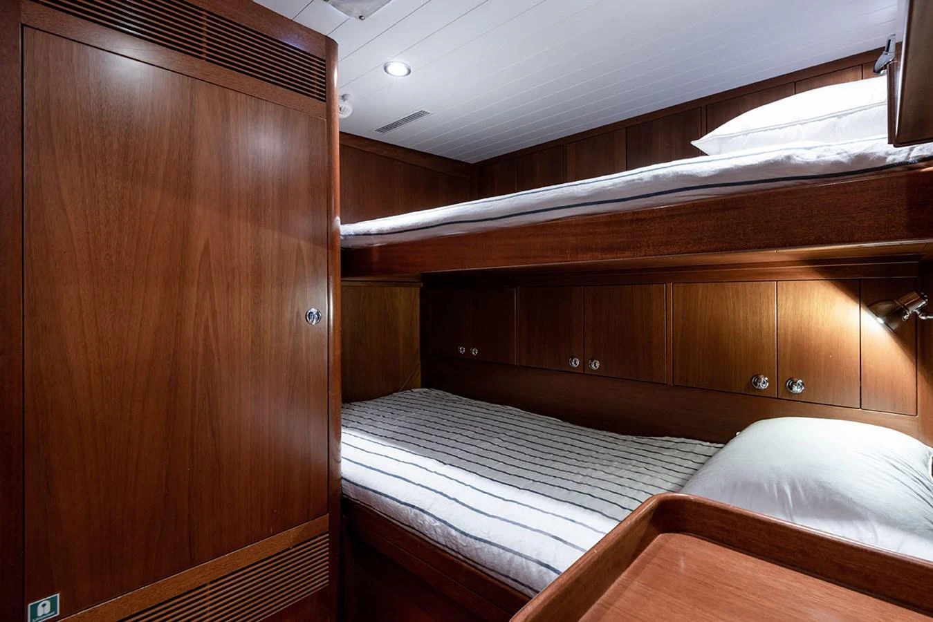a room with wooden cabinets aboard PATH Yacht for Sale