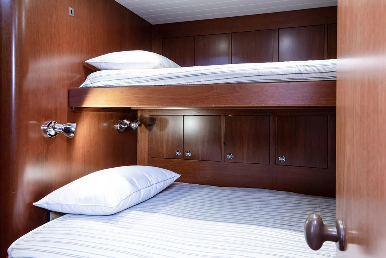 a bed with a white pillow aboard PATH Yacht for Sale